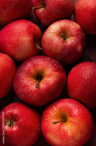 Fresh red apples forming appealing composition on dark background