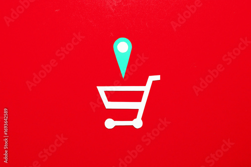 Paper cut shopping trolley and Geolocation Maps Marker point icon on red background