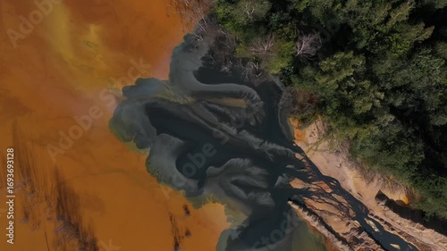 Flying over patterns of acid mine drainage in decanting lake  at Geamana, Romania