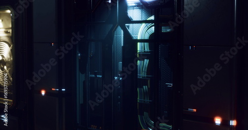 Fotografie In a dark corridor filled with sleek panels and soft glowing lights, intricate wires and devices line the walls