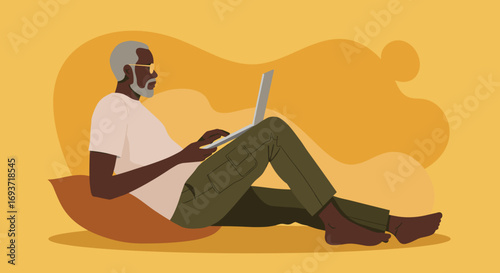 Elderly African American man comfortably working or relaxing with a laptop on a pillow. Represents modern seniors engaging with technology for business or leisure.