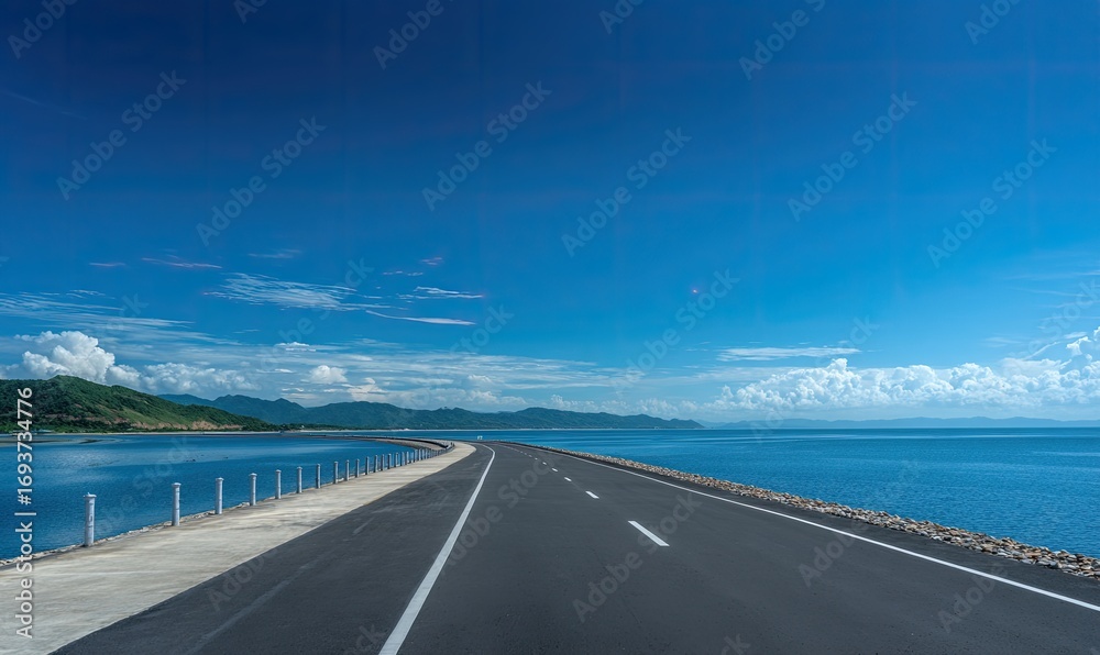 Fototapeta premium Coastal highway under a vibrant blue sky