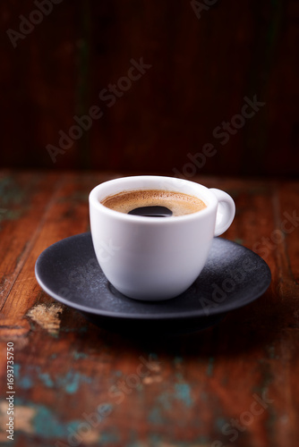 Cup of coffee on rustic wooden background. Soft focus. Copy space	
