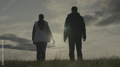 silhouette man and woman at sunset, hold partner's hand sun, teamwork, corporate happy farming group, successful business team, trust of successful people, joy of joining unity, raise your hands up.