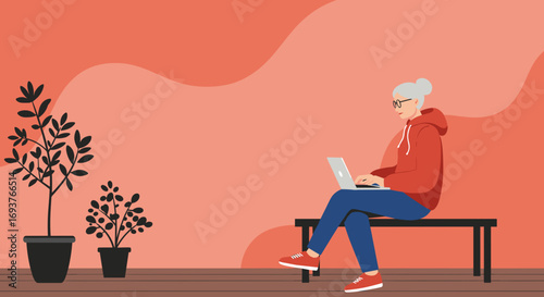 Senior woman comfortably uses a laptop, representing modern retirement, digital literacy, and flexible work/learning in a relaxed home environment.