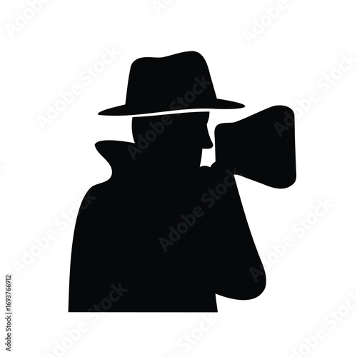 Silhouette of a man in a trench coat with a fedora hat