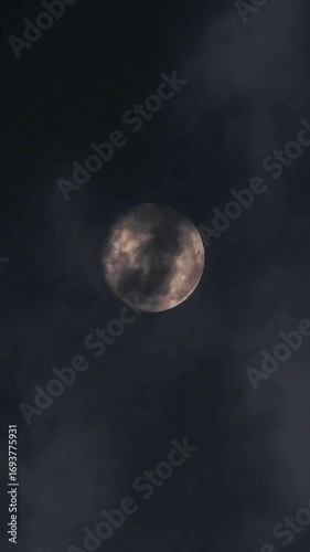 full moon over dark clouds