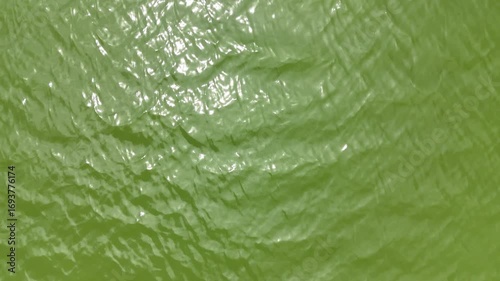 Abstract fluid surface video background with light reflections and subtle ripples creating a sense