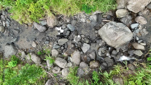 Serene Waterscape Rocky Stream Flowing Gently Through Lush Greenery, Creates a Relaxing Environment