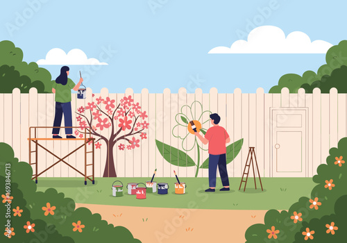 Two people painting a large flower mural on a white fence in a backyard garden