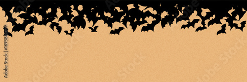 Spooky Halloween banner with a swarm of flying black bats on a textured orange background. Ideal for party invitations, banner, sale, decorations, and seasonal holiday designs
