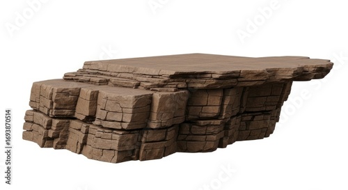 A brown layered rock formation with a flat top and rough cracked surfaces shown on a white background