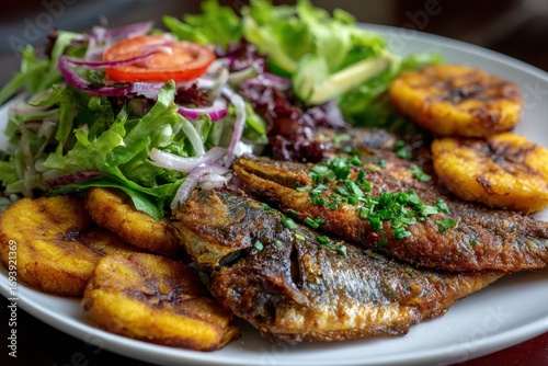 Fototapeta Naklejka Na Ścianę i Meble -  Fried fish with plantains and salad on a white plate, close-up shot. Showcase healthy, tasty and balanced food for restaurant or blog posts.