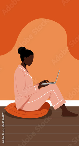 Relaxed person in pajamas working on a laptop at home, emphasizing remote work, comfort, and productivity from a cozy personal space.