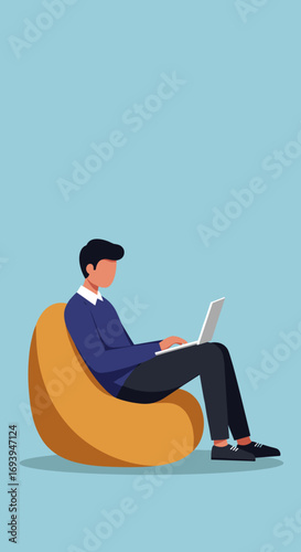 Man working comfortably on a laptop from a bean bag chair, illustrating remote work, online learning, or freelance lifestyle.