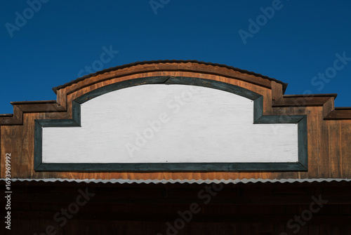 Empty white wooden signboard hanging on an aged wall. Western wooden building in Arizona, USA. Old farmer's house.