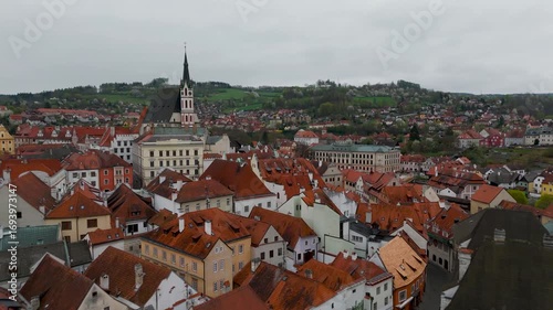 Wallpaper Mural Aerial approach over the historic rooftops of Cesky Krumlov Old Town toward the Church of St. Vitus and central square in Czech Republic. Torontodigital.ca