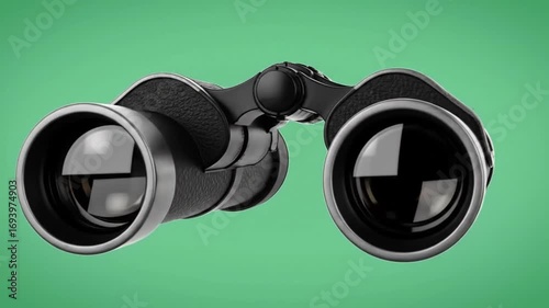 Powerful binoculars poised focused against green