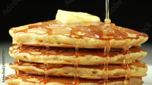 Stacked pancakes drenched in syrup perfection