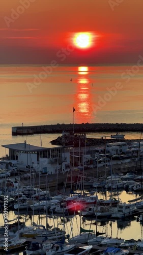 A tranquil sunset reflects over a serene marina, ideal for peaceful vibes and beautiful waterfront scenery, Helsingborg, Sweden