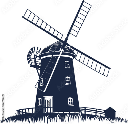 An old Dutch windmill, a historic wooden building, stands on a rural hill against the evening sky
