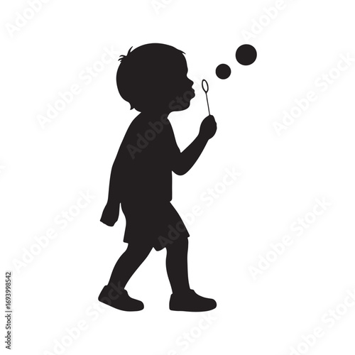 Silhouette of a child happily blowing bubbles outdoors on a bright day.