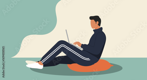 Man in casual attire using a laptop while sitting comfortably on a cushion. Ideal for remote work, online learning, or flexible modern lifestyle concepts.
