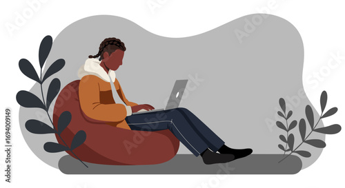 Young person comfortably working on a laptop from home, embodying remote work, digital lifestyle, and online learning in a cozy setting.