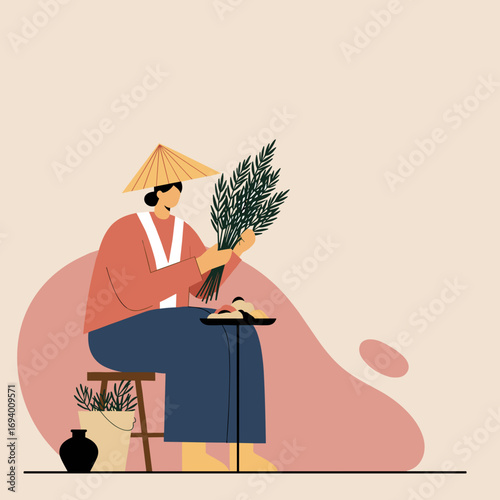 Person in a conical hat bundles fresh green plants, perhaps herbs or rice, while sitting next to traditional food, depicting a tranquil scene of cultural work or craft.
