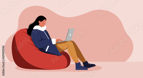 Comfortable woman works on laptop from a bean bag chair, perfect for remote work, study, or leisure activity.