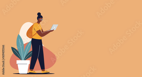 Modern person wearing glasses, standing and focused on a laptop. Depicts remote work, online learning, or a flexible digital lifestyle.