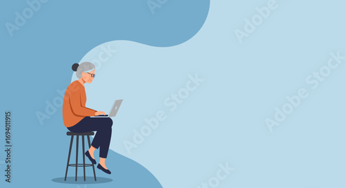 Senior woman in glasses diligently using a laptop while sitting on a stool, embodying digital literacy, online connection, and an active modern lifestyle.
