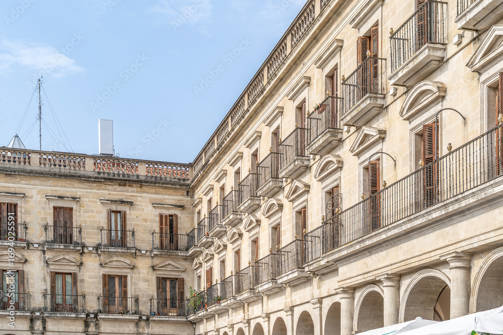 Fototapeta premium Historic Spain Square Neoclassical Architecture in Vitoria Gasteiz Basque Country Spain. Portico arches, balconies, stone facades, town hall square