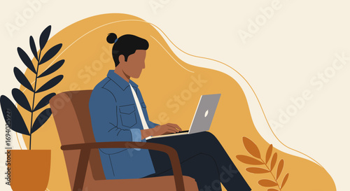 Young man focused on his laptop while sitting in a comfortable armchair at home. Ideal for concepts of remote work, productivity, and flexible lifestyle.