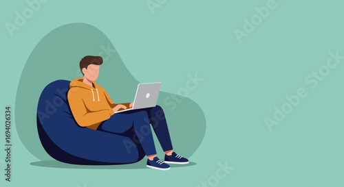 Young person comfortably working or studying on a laptop while sitting on a bean bag chair. Ideal for remote work, online learning, or digital leisure concepts.