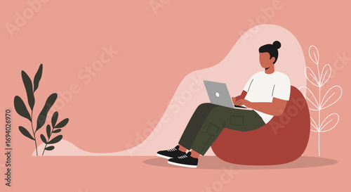 Person comfortably working on a laptop from a beanbag chair in a minimalist setting. Represents remote work, online learning, and flexible modern lifestyle.