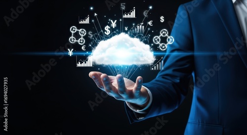 Businessman holding cloud computing with financial icons on dark background