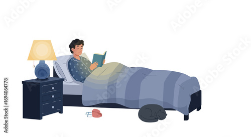 Young man reading a book in bed before sleep.