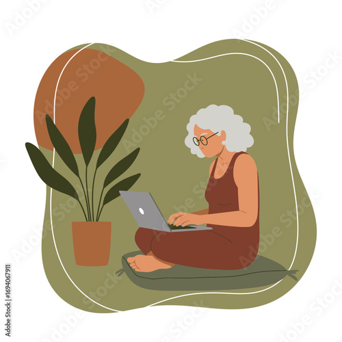 Mature woman with glasses using laptop at home, sitting comfortably with a plant nearby. Represents senior tech use, remote work, or online learning, showing modern lifestyle.