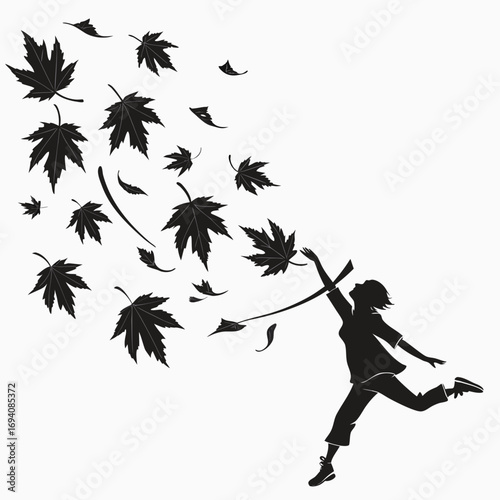 Silhouette of a person jumping among falling leaves