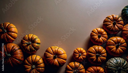 pumpkins of different sizes on a dark background with space for text