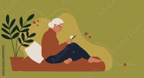 Relaxed senior woman engaging with her smartphone at home, illustrating modern digital literacy, connectivity, and leisure for older adults.