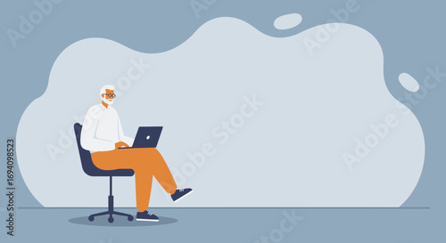 Mature man working remotely on his laptop, sitting comfortably on an office chair. Ideal for business, technology, and senior lifestyle concepts with ample copy space.