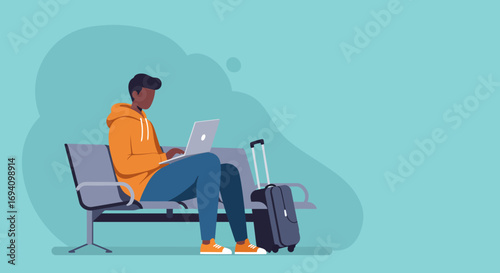 Young man working on his laptop while waiting with luggage at an airport or station. Represents remote work, travel, and modern connectivity.