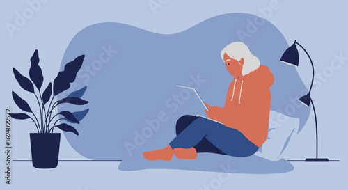 Older woman comfortably working or learning on a laptop at home, showcasing remote productivity, online connection, and a modern digital lifestyle.