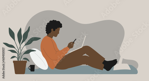 Modern person engaged in remote work or digital communication, comfortably multitasking with laptop and smartphone at home. Represents flexible work, online learning, and connected lifestyle.