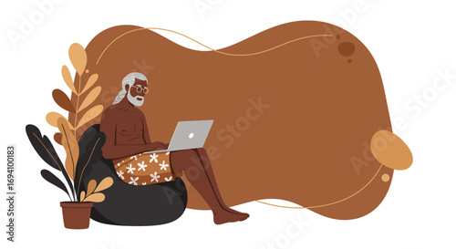 Relaxed senior man uses laptop on bean bag chair, embodying remote work, digital nomad lifestyle, and leisure productivity. Ideal for modern living, travel, and business.