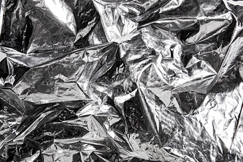 Abstract metallic foil background with crumpled and reflective surface