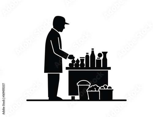 Silhouette of a man selling goods from a cart