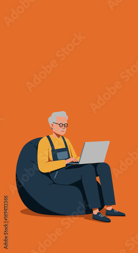 Elderly man comfortably using a laptop on a bean bag chair. Represents senior technology adoption, remote work, learning, or leisure.